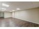 Finished basement features wood-look floors, neutral walls, and recessed lighting at 7928 S Giles Rd, Douglasville, GA 30135
