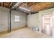 Unfinished basement with exposed ceiling beams and concrete floors at 7928 S Giles Rd, Douglasville, GA 30135