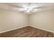 Finished basement space features wood laminate floors, neutral walls, and updated ceiling fan at 7928 S Giles Rd, Douglasville, GA 30135
