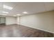 Large basement area with wood floors, neutral paint, and square lights at 7928 S Giles Rd, Douglasville, GA 30135