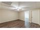 View of basement featuring wood floors, a ceiling fan, and a door to another room at 7928 S Giles Rd, Douglasville, GA 30135