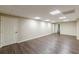 Spacious basement with wood floors, recessed lights, and neutral paint at 7928 S Giles Rd, Douglasville, GA 30135