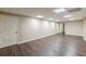 Spacious basement with wood-look floors, neutral walls, and drop ceiling at 7928 S Giles Rd, Douglasville, GA 30135