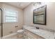 Bright bathroom featuring granite countertop, updated fixtures, and natural light at 7928 S Giles Rd, Douglasville, GA 30135