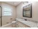 Bathroom featuring granite vanity, shower, and window at 7928 S Giles Rd, Douglasville, GA 30135