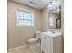 Bathroom features a modern vanity, updated toilet, and a bright window for natural light at 7928 S Giles Rd, Douglasville, GA 30135