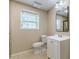 Bathroom features a window, vanity, toilet, and tiled shower at 7928 S Giles Rd, Douglasville, GA 30135