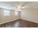 Bedroom showcasing wood-look flooring, neutral walls, and two windows, creating a cozy space at 7928 S Giles Rd, Douglasville, GA 30135