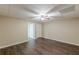 Spacious bedroom featuring wood-look floors, neutral walls, and a ceiling fan at 7928 S Giles Rd, Douglasville, GA 30135