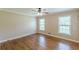 Bright bedroom with hardwood floors and large windows filling the room with natural light at 7928 S Giles Rd, Douglasville, GA 30135