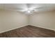 Neutral bedroom featuring wood floors, a ceiling fan, and fresh paint at 7928 S Giles Rd, Douglasville, GA 30135