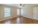 Bedroom featuring hardwood flooring, two windows, ceiling fan and neutral paint at 7928 S Giles Rd, Douglasville, GA 30135