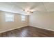 Bedroom featuring wood-look floors, neutral walls, and a ceiling fan at 7928 S Giles Rd, Douglasville, GA 30135