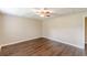Bedroom featuring wood-look flooring, neutral walls, and a ceiling fan, creating a cozy space at 7928 S Giles Rd, Douglasville, GA 30135