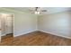 Bedroom featuring hardwood floors, neutral walls, and open closet door at 7928 S Giles Rd, Douglasville, GA 30135