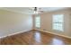 Bedroom featuring hardwood floors, two windows, and ceiling fan at 7928 S Giles Rd, Douglasville, GA 30135