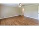 Bedroom showing hardwood floors, neutral walls, and open closet door at 7928 S Giles Rd, Douglasville, GA 30135