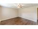 Bedroom featuring wood-look floors, neutral walls, and a ceiling fan at 7928 S Giles Rd, Douglasville, GA 30135