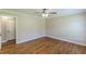 Spacious bedroom featuring hardwood flooring, ceiling fan, and neutral wall color at 7928 S Giles Rd, Douglasville, GA 30135