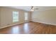 Spacious bedroom featuring hardwood floors, two windows, ceiling fan, and neutral paint at 7928 S Giles Rd, Douglasville, GA 30135