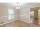 Bright dining area featuring wood look tiled floors, a window view, and neutral decor at 7928 S Giles Rd, Douglasville, GA 30135