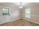 Cozy dining area with a window view and hardwood floors, adjacent to a kitchen at 7928 S Giles Rd, Douglasville, GA 30135