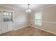 Cozy dining room with tile floors, neutral walls, a modern light fixture, and a view to the outside at 7928 S Giles Rd, Douglasville, GA 30135