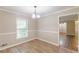 Dining room with wood-look tile flooring, neutral paint, and a large window providing natural light at 7928 S Giles Rd, Douglasville, GA 30135