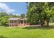 Charming single-story brick home with a landscaped front yard and inviting front porch at 7928 S Giles Rd, Douglasville, GA 30135