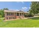 A well-maintained brick home with black shutters, landscaping, and a welcoming front porch at 7928 S Giles Rd, Douglasville, GA 30135