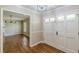 Welcoming foyer with hardwood floors, a double front door, and an open view into the adjacent dining room at 7928 S Giles Rd, Douglasville, GA 30135
