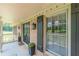 Inviting front porch with brick accents, stylish black door with decorative lanterns, and black window shutters at 7928 S Giles Rd, Douglasville, GA 30135