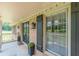 Inviting front porch with classic columns, black door, and lush landscaping details at 7928 S Giles Rd, Douglasville, GA 30135
