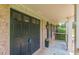 Welcoming double front door leading to the front porch with a potted plant at 7928 S Giles Rd, Douglasville, GA 30135
