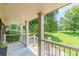 Relaxing covered front porch featuring brick accents, view of expansive yard, and room for seating at 7928 S Giles Rd, Douglasville, GA 30135