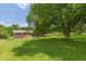 Spacious front yard with mature trees surrounding a charming brick home at 7928 S Giles Rd, Douglasville, GA 30135