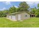 Detached two-car garage with additional storage space, set against a backdrop of trees at 7928 S Giles Rd, Douglasville, GA 30135