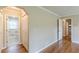 Hallway with hardwood floors, access to bathroom, and closet space at 7928 S Giles Rd, Douglasville, GA 30135