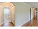 Hallway featuring hardwood floors, closet, and access to the bathroom at 7928 S Giles Rd, Douglasville, GA 30135
