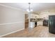 Functional kitchen with wood look tiled floors, black appliances, and efficient layout at 7928 S Giles Rd, Douglasville, GA 30135