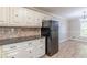 The kitchen features granite counters, brick backsplash, white cabinets, and an eat-in area at 7928 S Giles Rd, Douglasville, GA 30135