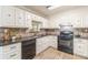 Updated kitchen with granite countertops, brick backsplash, and white cabinets at 7928 S Giles Rd, Douglasville, GA 30135