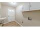 Functional laundry room with a utility sink, tile floors, and lots of storage at 7928 S Giles Rd, Douglasville, GA 30135
