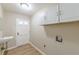 Functional laundry area features storage cabinets and a utility sink at 7928 S Giles Rd, Douglasville, GA 30135