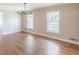 Bright living room featuring hardwood floors, neutral paint, chandelier, and lots of natural light at 7928 S Giles Rd, Douglasville, GA 30135