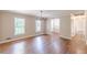 Large living room featuring hardwood floors, neutral paint, chandelier, and lots of natural light at 7928 S Giles Rd, Douglasville, GA 30135