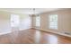 Living room boasts hardwood floors, neutral paint, and two windows for ample natural lighting at 7928 S Giles Rd, Douglasville, GA 30135
