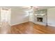 Inviting living room with hardwood floors, a cozy stone fireplace, and access to other areas of the home at 7928 S Giles Rd, Douglasville, GA 30135