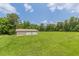 Detached garage/outbuilding with a two-car garage, expansive backyard, and mature trees at 7928 S Giles Rd, Douglasville, GA 30135