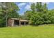 Open shed in the backyard, surrounded by lush greenery at 7928 S Giles Rd, Douglasville, GA 30135